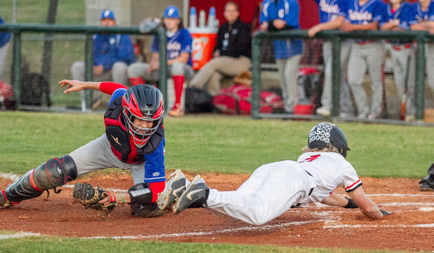 Patton's Kanton Trull (right) slides in headfirst to beat the throw to home plate against Freedom on Monday.