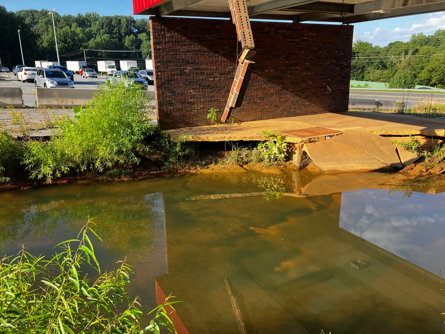 The giant sinkhole next to the Morganton Post Office remains a threat to both nearby roads and to the Catawba River.