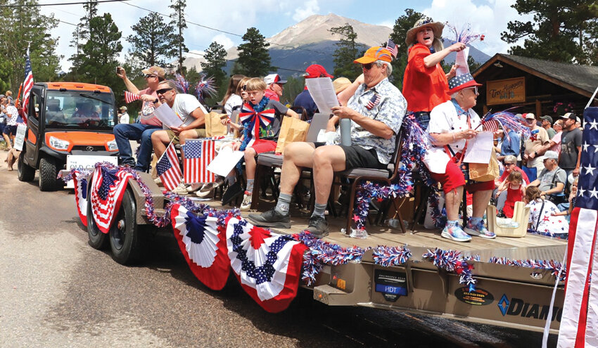 Members of the Allenspark Community Church ride through the Fourth of July parade.