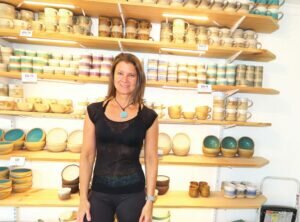 Art around us Martina Pernicano stands with her pottery during the Studio Tour. Pernicano makes a variety of cups and bowls and other useful everyday pottery. She makes them in her studio in Coal Creek Canyon. PHOTO BY JOHN SCARFFE