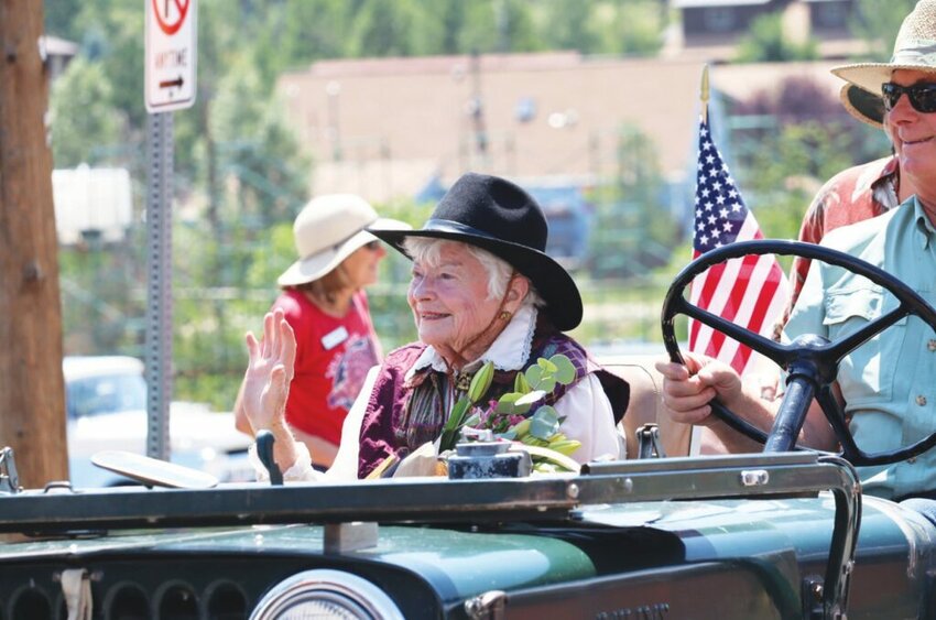 Nederland royalty honored Grand Marshal of the Nederland 150th parade Jeanette Smith waves to the crowd after receiving a Lifetime Achievement Award from the Nederland Area Historical Society.