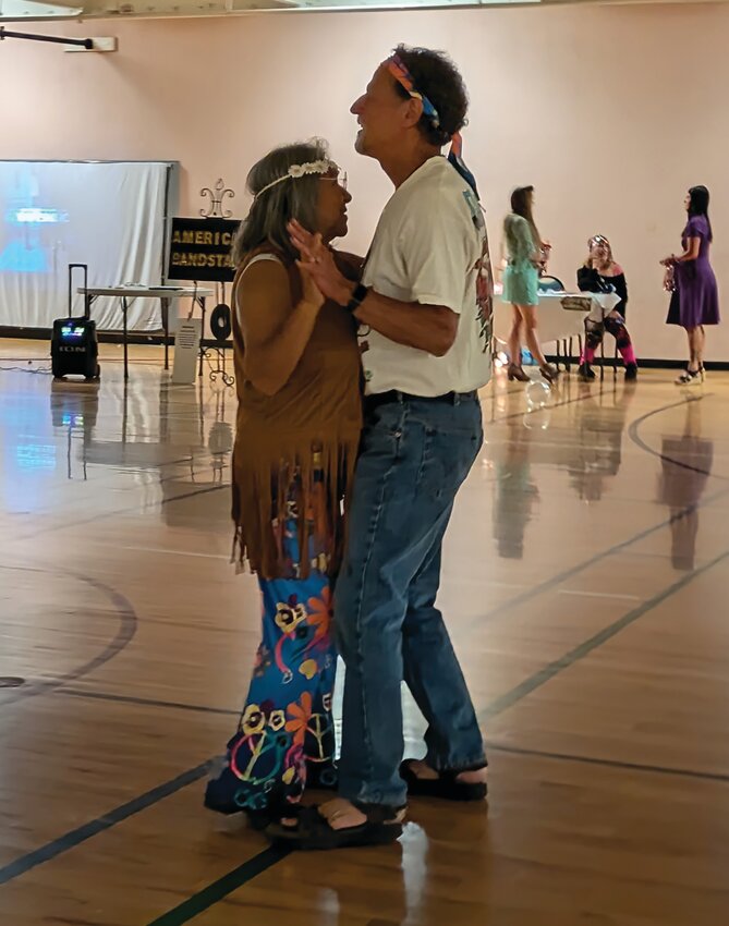 Channeling her inner hippie, Commissioner Marie Mornis grooves with her partner at the Friends of Gilpin County Community Center&rsquo;s lively fundraiser dance.