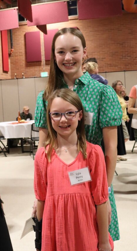 <p><strong>Runs in the family</strong></p><p>Sisters in life and in art, Maddie Perry poses with Lyla, who entered her art for the first time.</p>