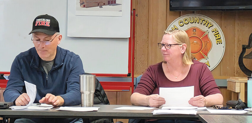 Board leadership at workTimberline Fire Protection District Vice Chairman John Bushey and Board Member Kristin Turner review documents during the March 11 board meeting in Black Hawk.