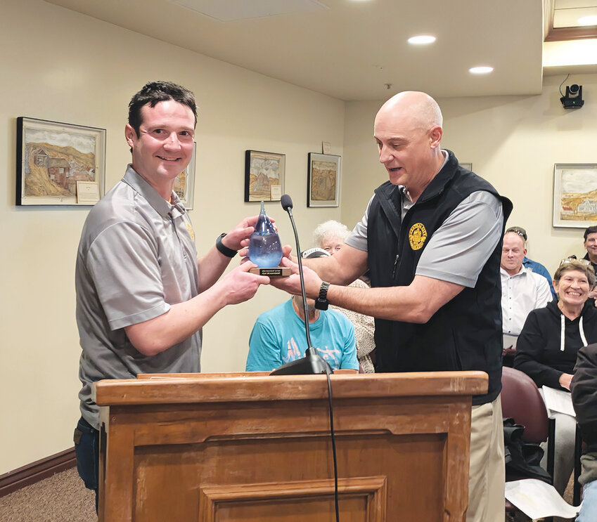 Recognizing servicePublic Works Director Mark Johns presents Alex Skladanowski with a beautiful award in the shape of a water droplet for his dedication to the Water Department.