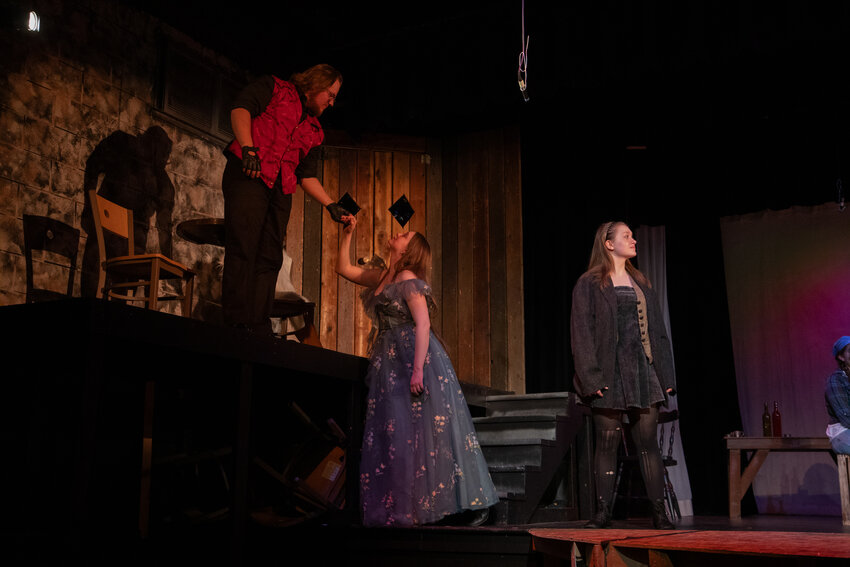 Hades in chargeMorgan Lake as Hades (left), Hazel Kelley as Persephone (center), and Lola Kelley as Eurydice (right) in Hadestown: Teen Edition.