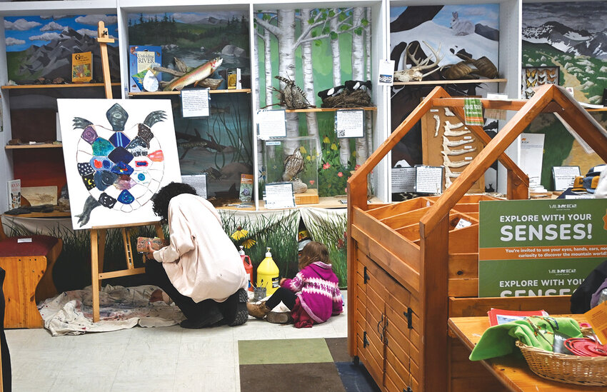 Turtle paintingA woman and child engage in Earth Day activities at Wild Bear Nature Center on April 19. 