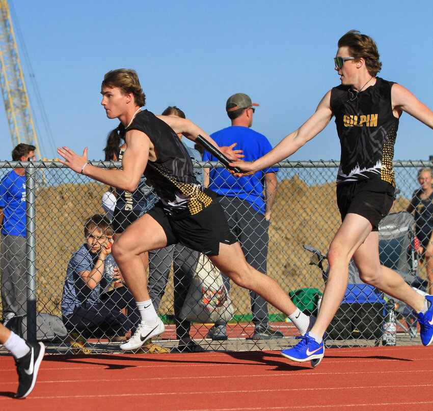 Boys 4x100m RelayLandon Church hands off to Connor Holloway in their record-setting race.