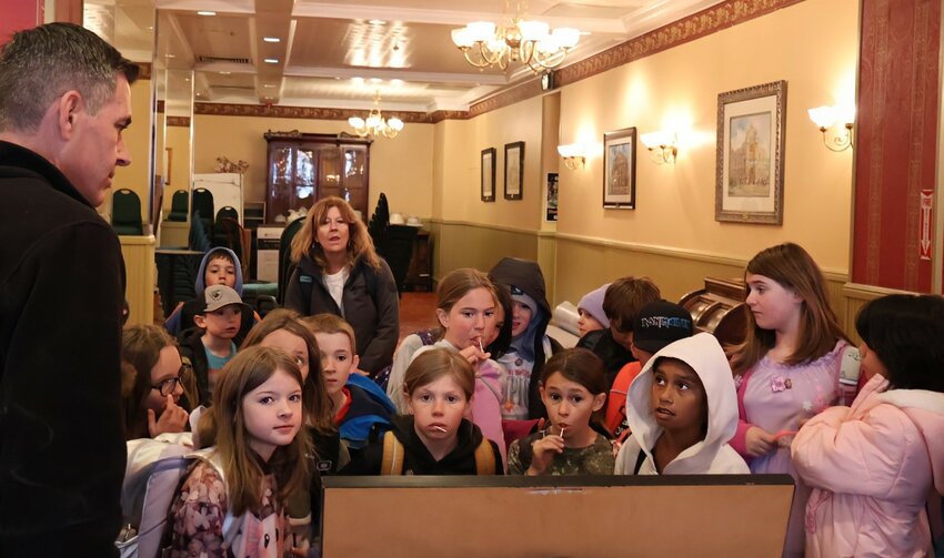 Past and presentEric Chinn shows children how furnishings in the Teller House connect to images from its storied past.