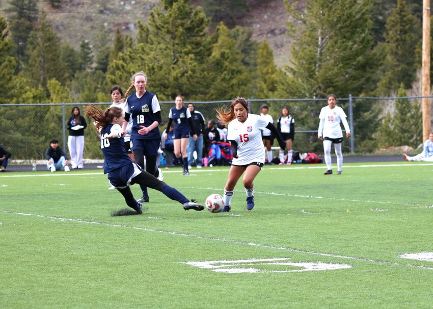Power defenseSophomore Evelyn Leary stretches just enough to tip the ball out of the path of an Aurora West player.
