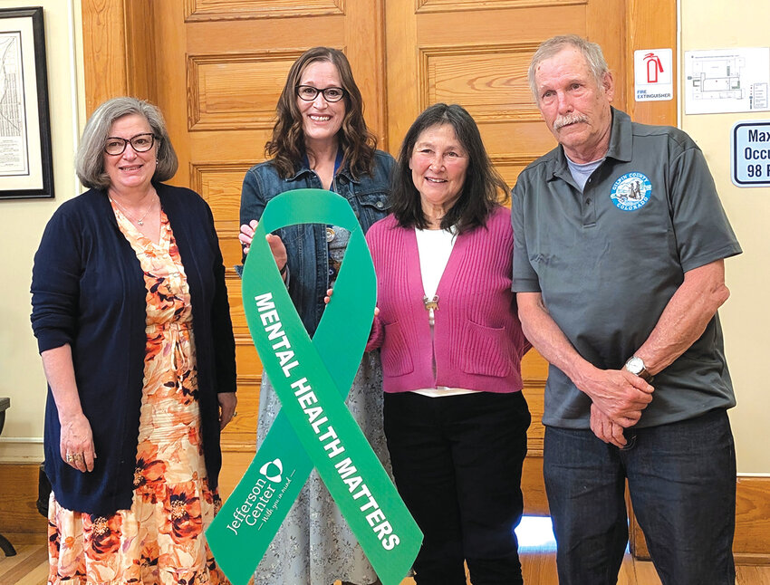 Mental health mattersFrom the left, Commissioner Susan Berumen, Tasha Holtzman of the Jefferson Center, and Commissioners Sandy Hollingsworth and Jeff Aiken hold a giant ribbon commemorating May as Mental Health Awareness Month.