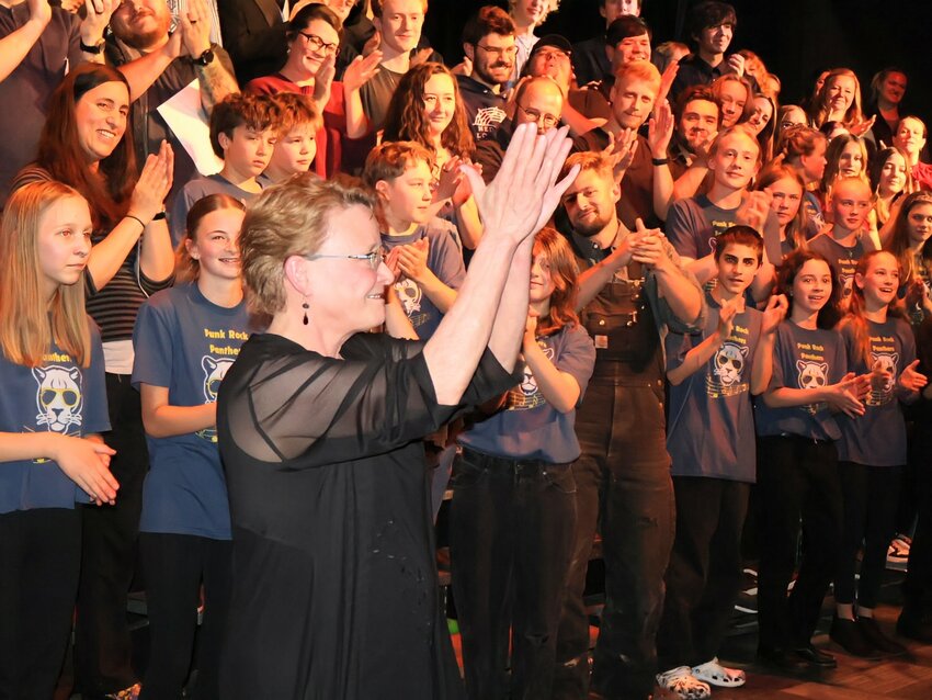 Standing ovationStudents, alumni, and audience members cheer and applaud Elizabeth Evans at the close of the Nederland Middle-Senior High School choir concert.