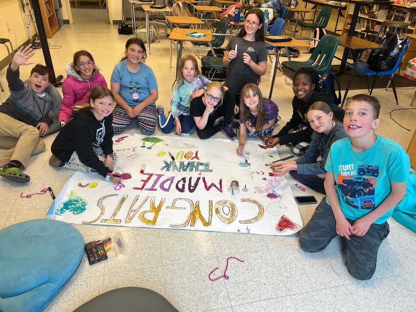 Gilpin sixth graders thank Maddie LaneSixth graders at Gilpin Secondary School put finishing touches on a "Thank You" banner for their teaching assistant, Maddie Lane, who is a 2025 graduate from the school.