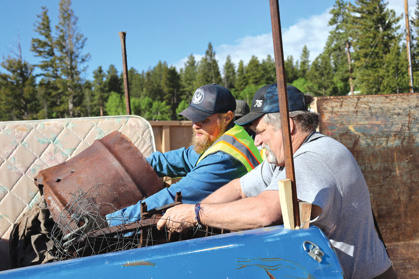 Town Works at workNederland Streets Department Manager Joshua Davis (left) works alongside a local to clear out a hefty haul.