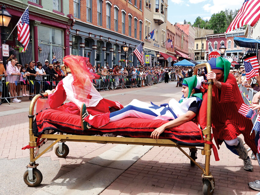 Opera on wheelsCentral City Opera’s “Race Upon a Mattress” team barrels down Main Street in full costume, narrowly missing a barricade.