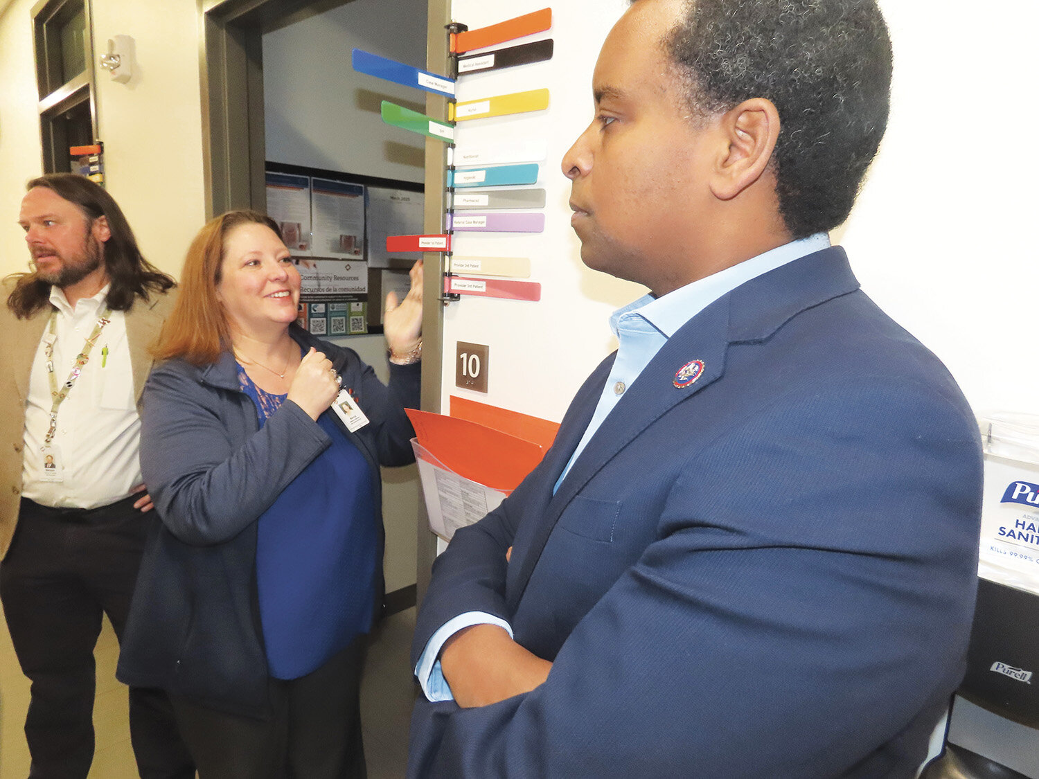 Sign in procedureRepresentative Neguse listens while staff show the sign-in and room procedure.