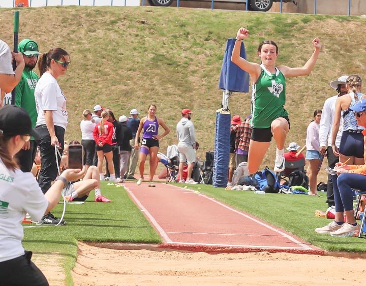 LONG JUMP -- Diane McGee (L) records  her daughter Micah McGee at the Long Jump pit during the San Angelo Relays on Saturday, March 23rd in San Angelo Stadium. McGee placed 14th in the event. She also competed in the Triple Jump and the 800 Meter Run. -- KATHY MANKIN | THE ELDORADO SUCCESS