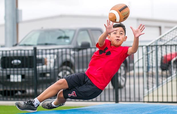 Isaiah Ramirez dives for a catch Tuesday during Reagan County’s Boys Sports Camp. Around 50 young athletes participated in the camp as coaches helped them sharpen their skills in football, baseball and basketball.