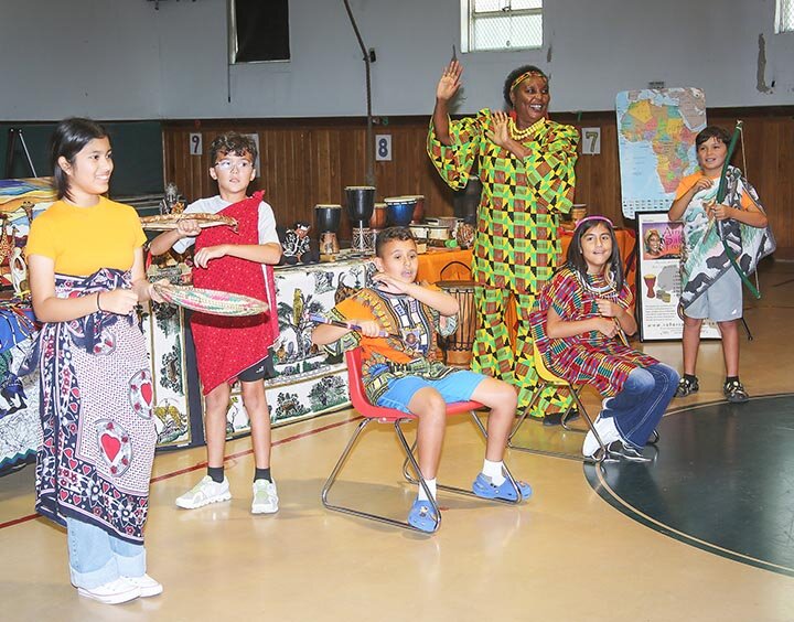 STUDYING AFRICAN CULTURES -- Elizabeth Kahura, a native of Kenya, was in Eldorado on Tuesday, October 8th, to teach Eldorado students about East African culture and lore. As part of the program, she had some of the students wear several articles of authentic African clothing, including fifth and sixth graders: (L-R) Melanie Alfaro – portraying a mother; Wesley Sissom, dressed as a soldier; Andrew Perez, wearing a king’s tunic; A’Marie Luna, clothed as a queen; and Zayden Gibson-Jalomo, in a soldier’s costume. Kahura’s program, sponsored by the Schleicher County Public Library and HCTC, was held in the elementary gym. -- KATHY MANKIN | THE ELDORADO SUCCESS