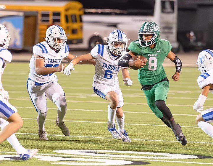 EAGLE ON THE LOOSE -- Eldorado Eagles quarterback Jonnie Rae Adame attracted a pack of Tahoka Bulldog defenders as he looked for running room around the left end of the line of scrimmage. Adame ran for two touchdowns and threw for another in the game that proved to be the season-ender for the Warbirds as the Bulldogs claimed the Bi-District crown with a 46-19 victory. -- 2RANDY MANKIN | THE ELDORADO SUCCESS