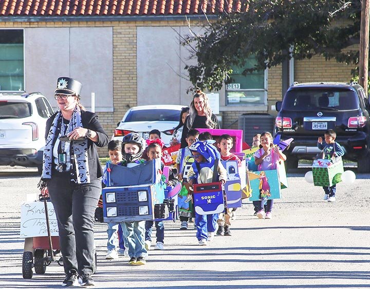 KINDERGARTEN THANKSGIVING PARADE -- Ms. Saunders and Ms. Cooper lead their students as they show off their Thanksgiving Parade creations. The parade featured such illustrious entries as Lightning McQueen, Spider Man, Sonic the Hedgehog and the U.S. Marine Corps Toys for Tots collection box. The colorful parade was held Friday morning, November 22nd as the students prepared for a week-long Thanksgiving break. -- KATHY MANKIN | THE ELDORADO SUCCESS