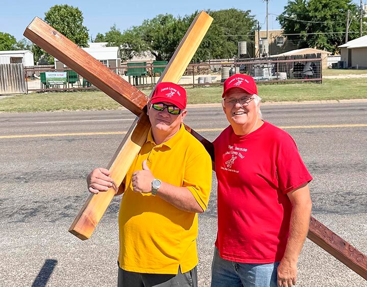 TAKING UP THEIR CROSS  -- Sam Prater, an Eldorado native, and Walter Masters of San Angelo paused for a photo as they took turns carrying a wooden cross through Schleicher County. The pair say they have made it their mission to display Jesus’ love for humanity by taking up their cross and carrying it throughout West Texas.  -- KATHY MANKIN | THE ELDORADO SUCCESS