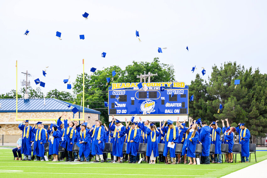  of the Reagan County High School Class of 2025 toss their caps in the air at the conclusion of their graduation ceremony Friday night at James H. Bird Memorial Stadium. A total of 56 seniors walked the stage to receive their diplomas in front of their family and friends.