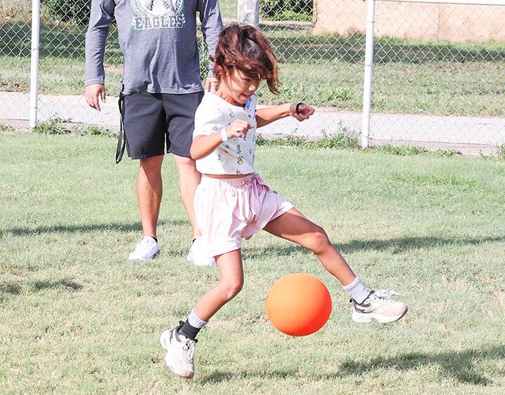 FANCY FOOTWORK -- Third grader Kahleia Medellin exhibits impressive ball-control skills during kick ball drills on Tuesday, June 2nd, at the Mega Sports Camp and Vacation Bible School held on the Eldorado Elementary campus and playground. -- KATHY MANKIN | THE ELDORADO SUCCESS