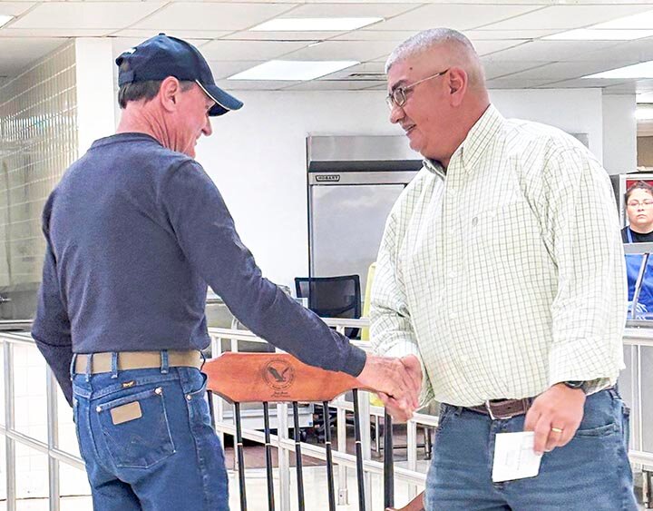 ROCKING INTO RETIREMENT -- SCISD Superintendent Oscar Aguero (R) congratulates Transportation Director Joey Jones (L) on his retirement and presented him with a rocking chair made from mesquite during the district’s staff appreciation luncheon on Friday, May 23rd. Jones spent 25 years at SCISD. Also retiring was Finance Director Lynn Holsey who retired after 33 years, 13 of those being at SCISD. -- COURTESY PHOTO