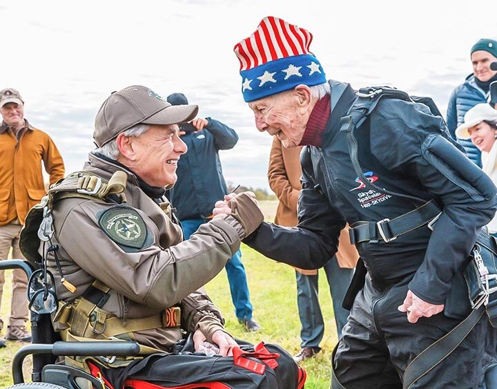 SAFELY BACK ON THE GROUND -- Governor Greg Abbott greets 106-year-old WWII veteran Al Blaschke after the pair made a successful skydive on Monday, November 27th at Skydive Spaceland in San Marcos. It was the governor’s first-ever jump. Mr. Blaschke made his first jump at age 100. -- | COURTESY PHOTO