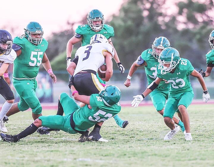 SURROUNDED BY WARBIRDS -- Andrez Gomez (52) secures the legs of a Junction runner as his teammates Ronin Herrera (55), Bradon Criswell (72), Josh Guzman (33) and Cole Meador (23) close in to finish the play on Thursday, October 10, 2024, as the Eldorado Eagles JV team hosted the Junction Eagles at Larry Mitchel Stadium. Junction won the game 16-0. -- MANDI UMPHRESS | THE ELDORADO SUCCESS