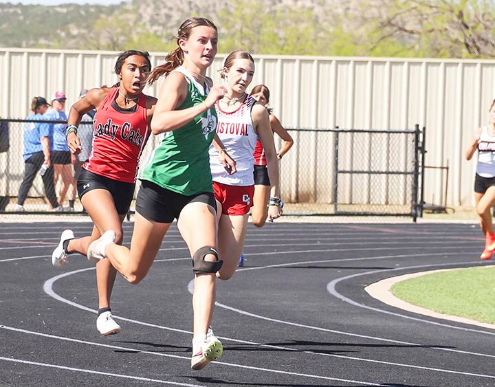 TURBO CHARGED -- Micah leads the pack around the around the final curve and down the home stretch as she extends her lead in the 400 Meter Dash at the Area Track Meet held Thursday, April 10th in Sterling City. McGee placed first with a time of 58.97, breaking the school record she had set just a week earlier at the District 7-2A Meet in Ozona. She also placed first in the 200 Meter Dash (26.85) and 4th in the Triple Jump (35-1.5). -- KATHY MANKIN | THE ELDORADO SUCCESS