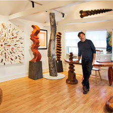 Inside and out of sculptor John Evans&rsquo; Broad Street studio at the Gr&aacute;ficas Gallery are a mixture of three-dimensional and two-dimensional pieces made of wood and bronze, and some paintings influenced by his sculptures. Evans, who has been sculpting for over 40 years, transforms pieces of indigenous woods like walnut and maple into shapes he describes as &ldquo;bent and twisted&rdquo;&ndash; a departure from much of the work seen around the island.
