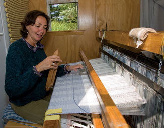 Karin Sheppard weaves an alpaca throw. She purchases Frog Tree alpaca yarn, produced by a nonprofit cooperative in South America for the Cape Cod-based T&C Imports.