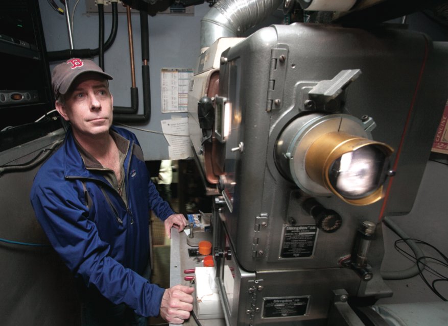 Starlight Theatre co-owner Mark Watson operates the theater’s old Simplex 35 film projector. By press time, it will be upgraded to a new digital projection system.