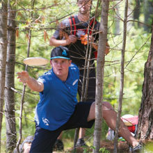 Professional disc-golfer Nate Doss launches a shot out of the trees during the second annual Nantucket Disc Golf Open this summer.