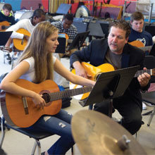 Erik Wendelken gives a guitar lesson to Jessie Lefebvre at Nantucket High School where he heads the music department.