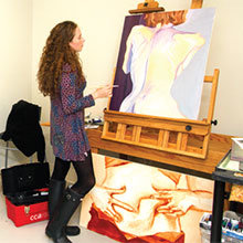 Evelyn Hudson rents a shared studio space in the Visual Arts Center to work on her painting.