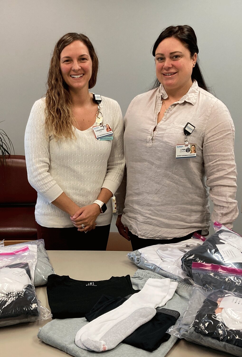 St. Lawrence Health assists patients with fresh clothing upon discharge. From the left are SLH Patient Experience managers Casandra Dodd and Lynn Scapicchio are shown with a few packets. Submitted Photo.