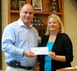 OHPA Chair Brian Reaves presents Fernandina Beach Mayor Sarah Pelican with $50,000 check.