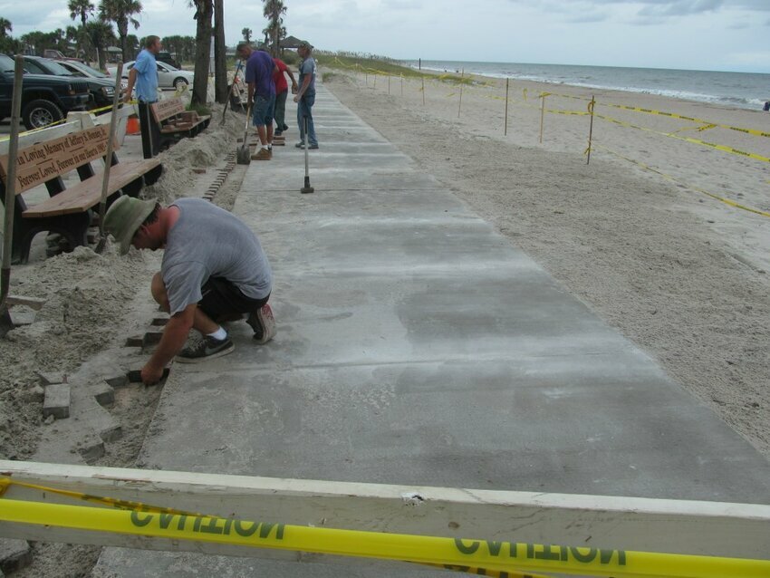 1.  Solar Pool heating panels being hoisted to Atlantic Center Roof.  Portion of Main Beach boardwalk renovation. From wood to concrete. 