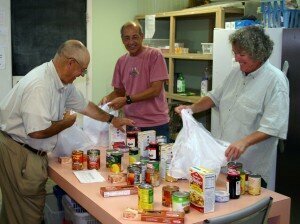 Volunteers stock the Barnabas Center pantry.