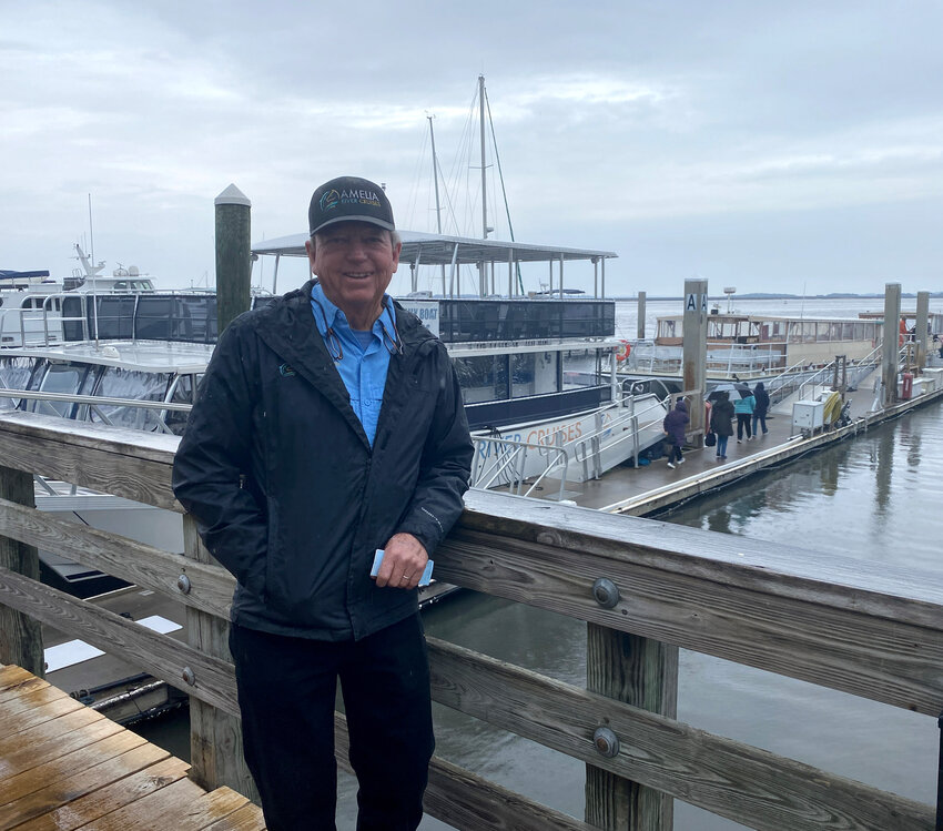 Kevin McCarthy poses in front of his fleet of three boats as passengers prepare to board the Miss Kaylynn.