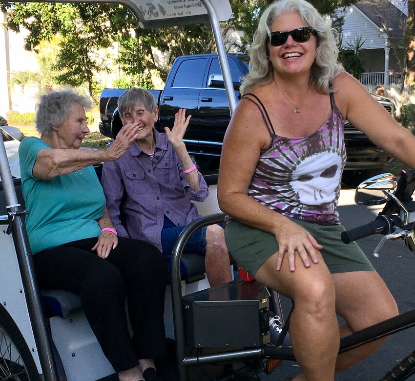 Two good friends share a pedicab ride.