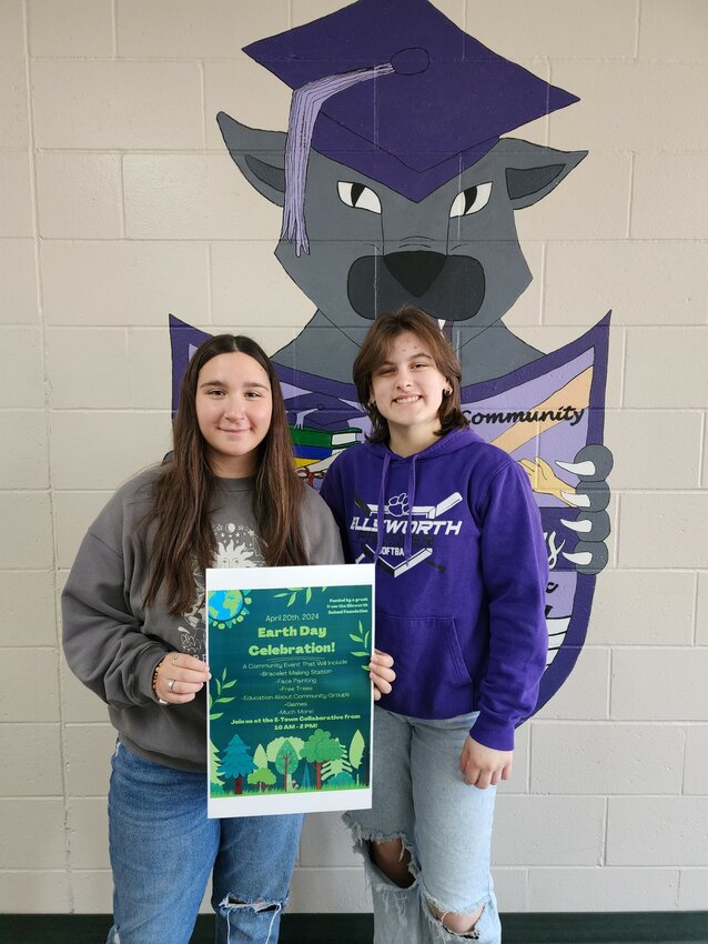Ellsworth High School seniors Maya Bueso (left) and Josie Pechacek show the poster for their April 20 Earth Day event, to be held at E-Town Collaborative.