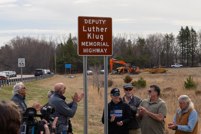 A sign honoring former Dakota County sheriff’s deputy Luther Klug, who was killed by a drunken driver 28 years ago, was unveiled by friends and former colleagues during a ceremony April 12 on County Road 68 in Ravenna Township.