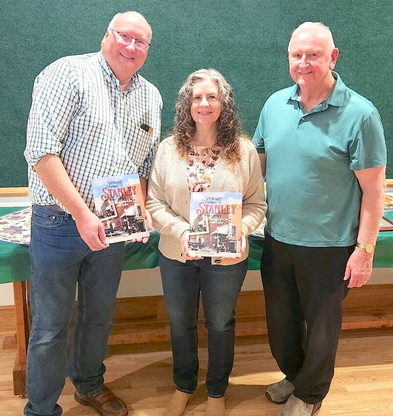 Stanley natives David Plummer (left), Michele Halterman, and David Jankoski display copies of the newly published book, ‘Vintage Views of Stanley-Brought to Life in Color,’ that is available to purchase from the Stanley Historical Society.