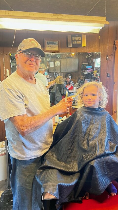 Donald “Jim” Kowalczyk has been cutting hair a long time. Above, he cuts the hair of his grandson Corey in 1983. At right, Daelynn Carroll, is the 5th generation in the Pilgrim family to have her hair cut by Jim the Barber.