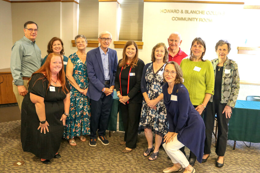 Library supporters with Governor Evers in the Howard and Blanche Collins Community Room at River Falls. From left to right (back row, from left) are Jim Ericksen, Michelle Ericksen, Cathy Ryba, Wisconsin Governor Tony Evers, Department of Administration Secretary Kathy Blumenfeld, Margie Konik, David Jankoski, Anne Diers, Pat Jankoski (front row) Nikki Witt and Jenny Sallis.