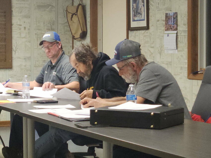 Chairman Michael Boehlke (left), Supervisor Andy Slowiak (center), and Supervisor Bob Kodl work on a revised ad for a new fulltime town employee.
